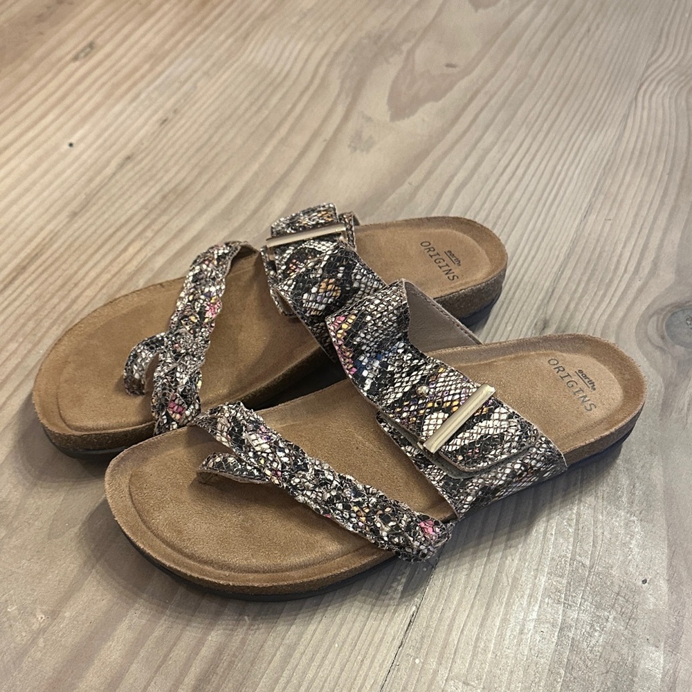 Women's snake skin print sandals with metallic accents.